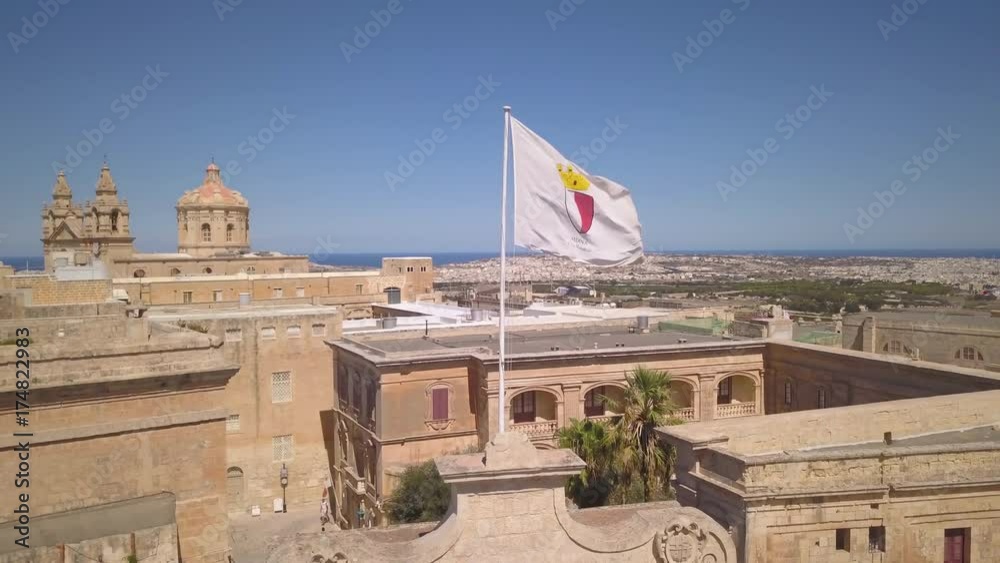 orbiting clockwise around flag in Mdina Malta