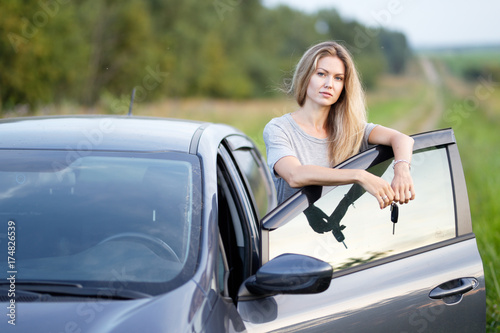 Young traveller woman standing outside car