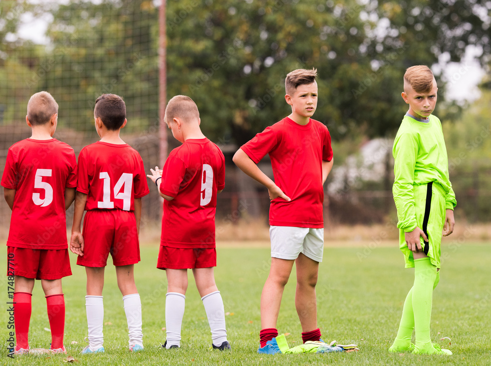 Kids soccer football - children players match on soccer field Kids soccer football - children players match on soccer field