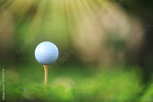 Golf ball on tee ready to be shot and nature background
