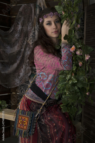 beauty hippie boho woman poses on a wooden background photo