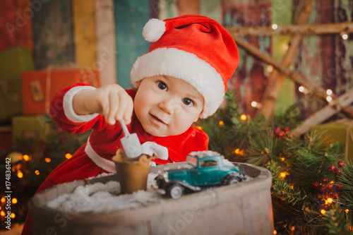 baby in Santa dress Christmas background photo