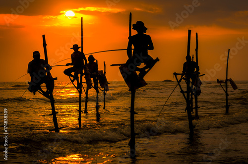 Silhouettes of the traditional fishermen photo