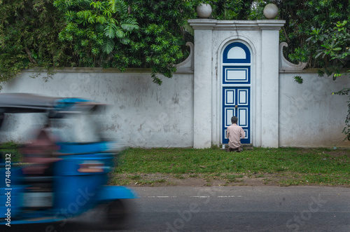 old man painting door in