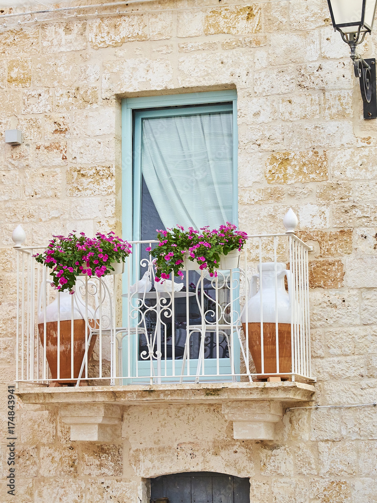 Typical balcony in a stone house of southern Italy.