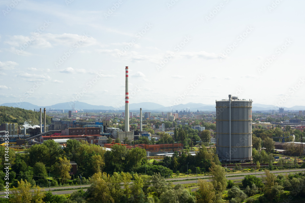 Ostrava cityscape - industrial factory and city. Beskid mountains ( Beskids ) in the background. Industrial town in the Czech Republic, Czechia