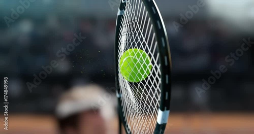 Tennis racket hit the tennis ball, in a super slow-motion, you see a deformation of the ball and small particles.