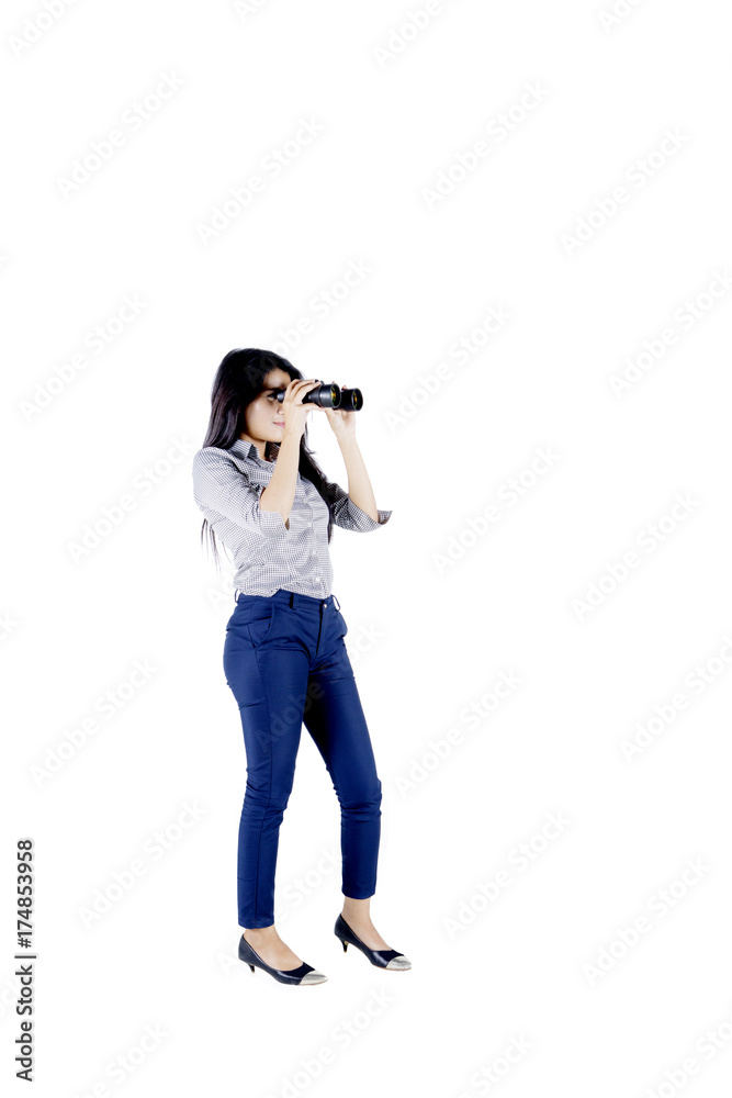 Young secretary using a binocular on studio Young secretary using a binocular on studio