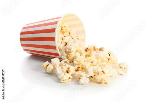 Paper cup and popcorn on white background