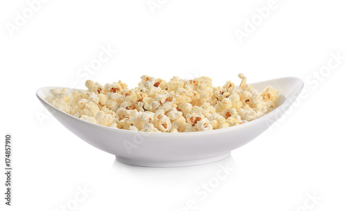 Plate with popcorn on white background