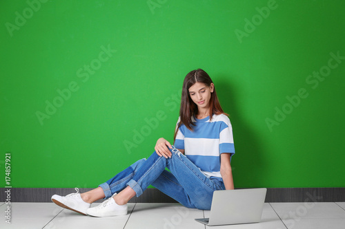 Young woman with laptop nea...