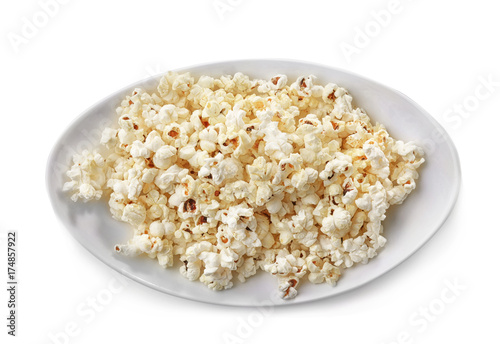 Plate with popcorn on white background