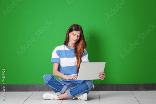 Young woman with laptop nea...