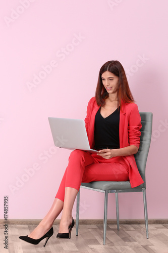 Young woman with laptop nea...