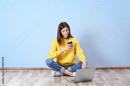 Young woman with laptop nea...