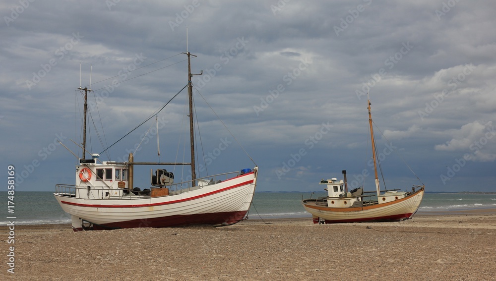 Two fishing boats on a cloudy summer day. Summer scene at Thorup beach, Denmark.