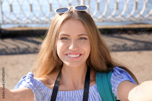 Beautiful young woman takin...