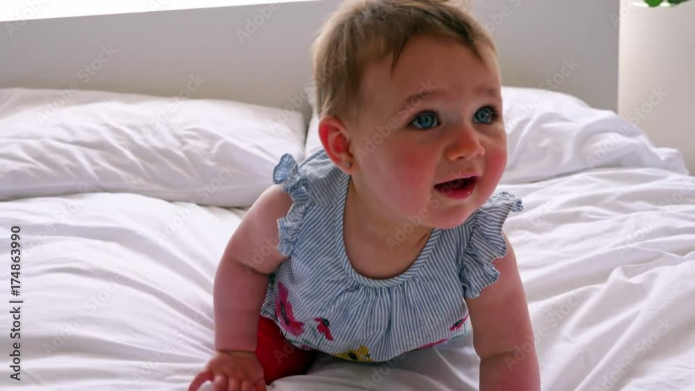 Portrait of a crawling baby on the bed in her room Portrait of a crawling baby on the bed in her room