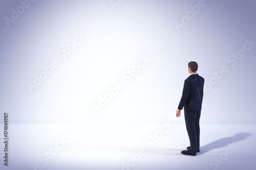 toy miniature businessman figure standing and looking at empty white lit space, concept background © dottedyeti