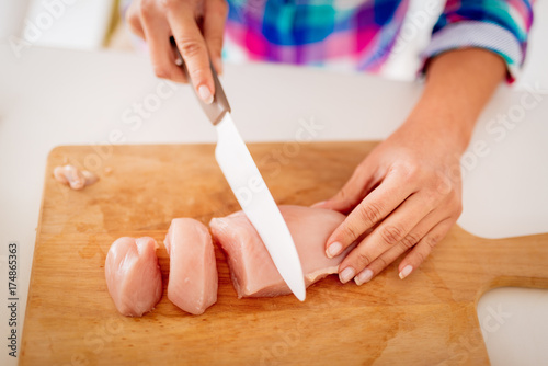 Female Hands Cutting Chicken Filet