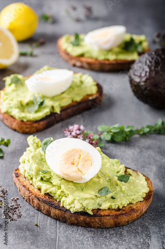 Bio avocado on bread with boiled egg