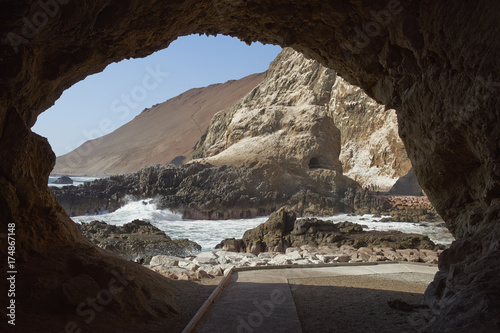 Anzota Caves at Arica on the coast of Chile. The area was used as a settlement by the Chinchorro people and later mined for guano deposited on the cliffs.