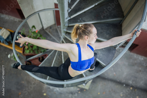 Young girl doing yoga outdoors in a park on the background photo