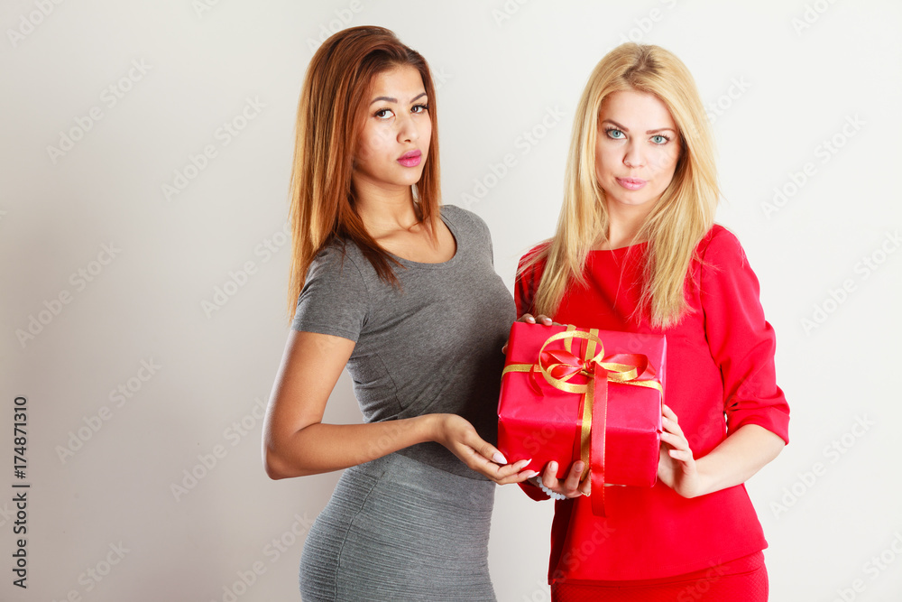 Two beautiful women with red gift box Two beautiful women with red gift box