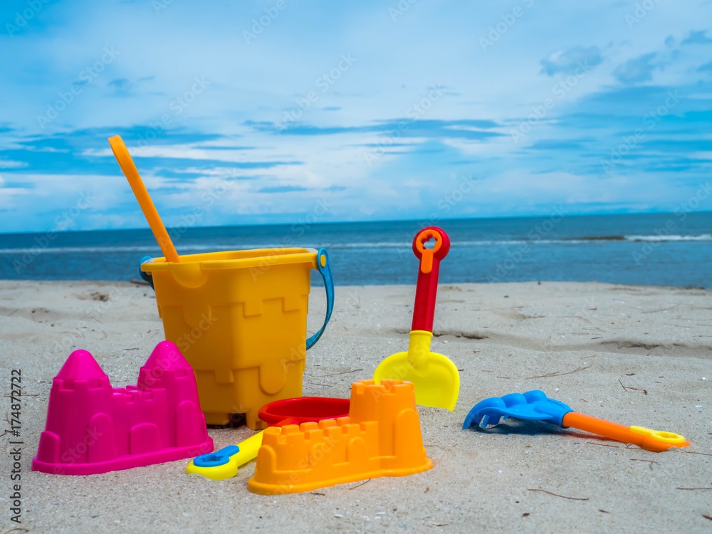 Summer time and kids toys on tropical sand beach Summer time and kids toys on tropical sand beach
