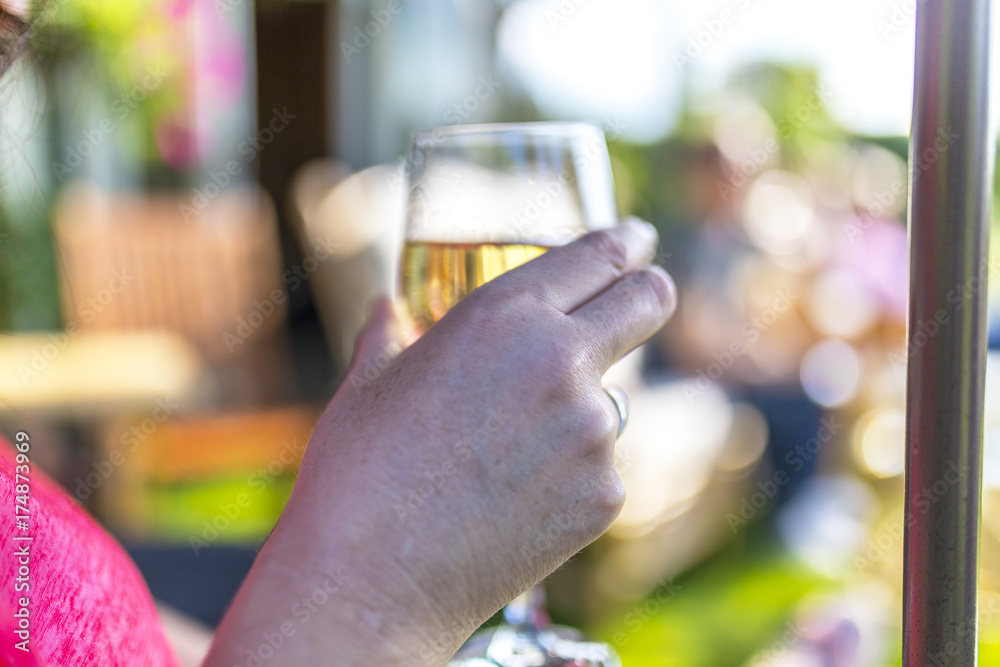 Dark haired woman drinking wine at a summer get together Dark haired woman drinking wine at a summer get together