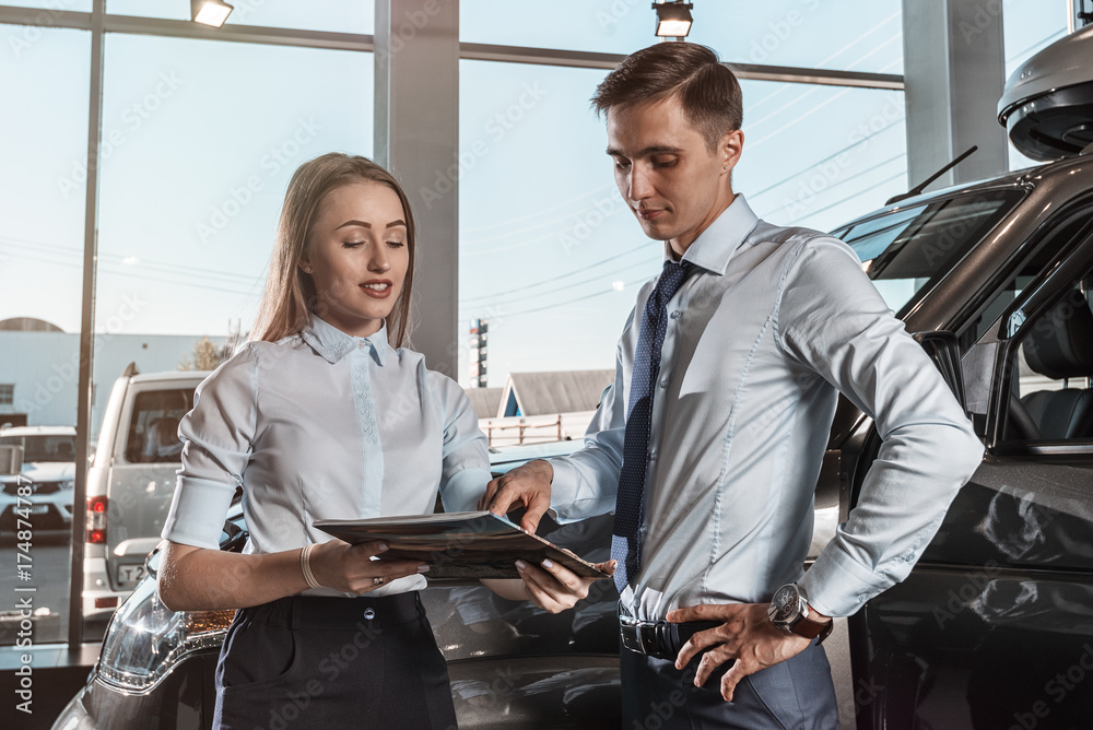 seller of cars/ Brutal stylish man at the wheel of a large car crossover seller of cars/ Brutal stylish man at the wheel of a large car crossover