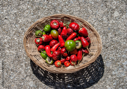 Variety of hot peppers in a small wicker basket photo