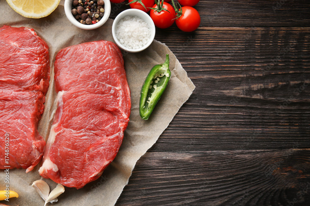 Fresh raw meat and spices on wooden table Fresh raw meat and spices on wooden table