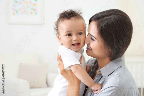 Mother holding cute baby af...
