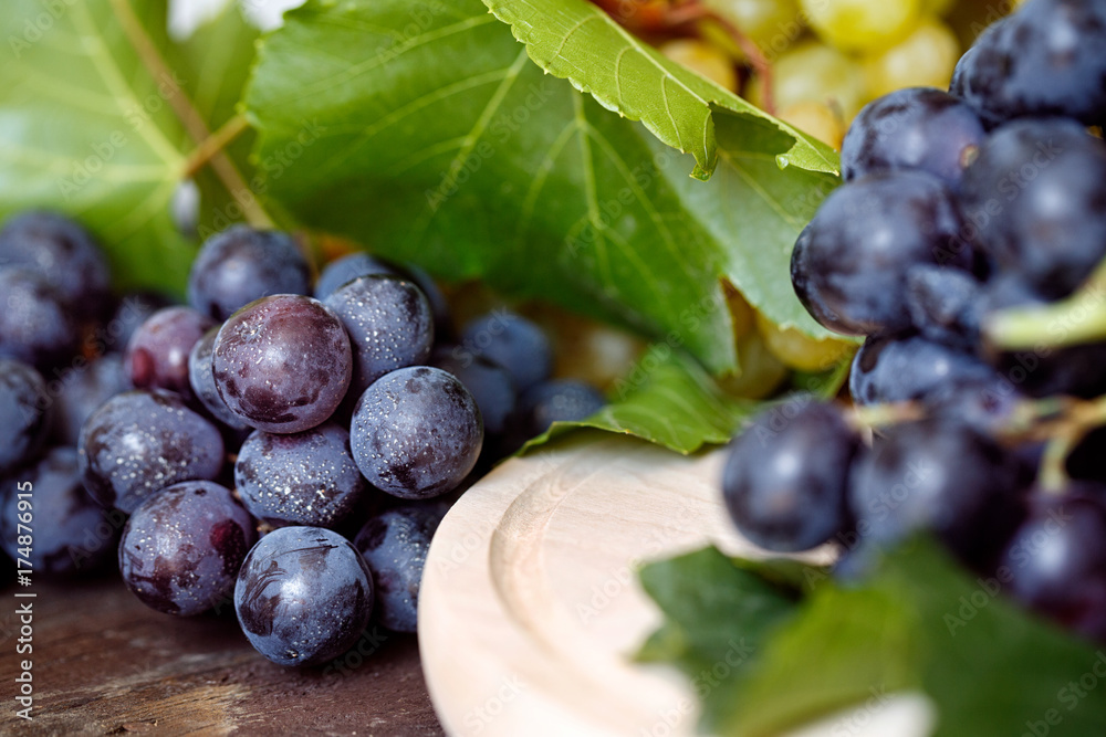 Fototapeta premium close up juicy black grapes on the table still life.