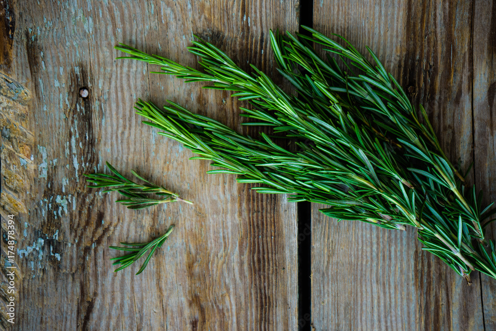 Rosemary spice on old wooden table Rosemary spice on old wooden table