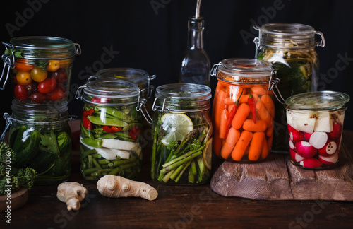 Preserved salted vegetables group assorted carrots cucumber peas variety conserve vegetables in mason jars canning fermented food concept 