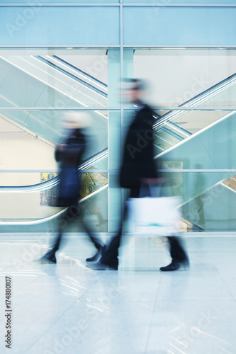 Commuters Walking Quickly down Hall in Office Building