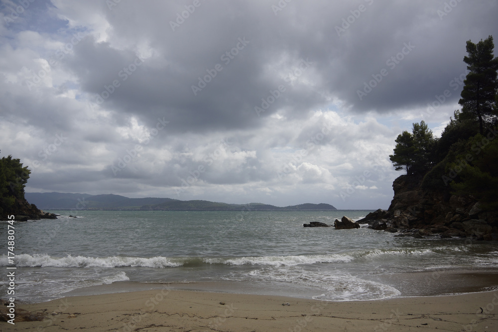 Kleine private Bucht mit Sandstrand bei stürmischem Wetter