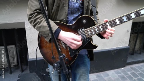 Liverpool, UK - October 10, 2015:A busker in Mathew Street playing Rockabilly guitar.