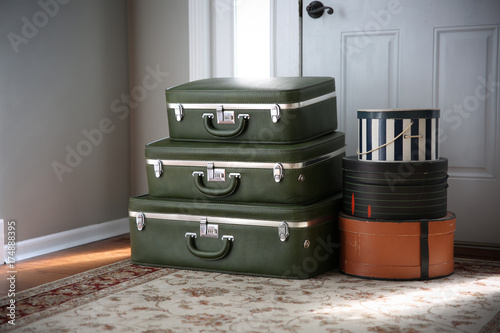 Obraz na plátne Set of vintage luggage and hatboxes waiting by the front door.