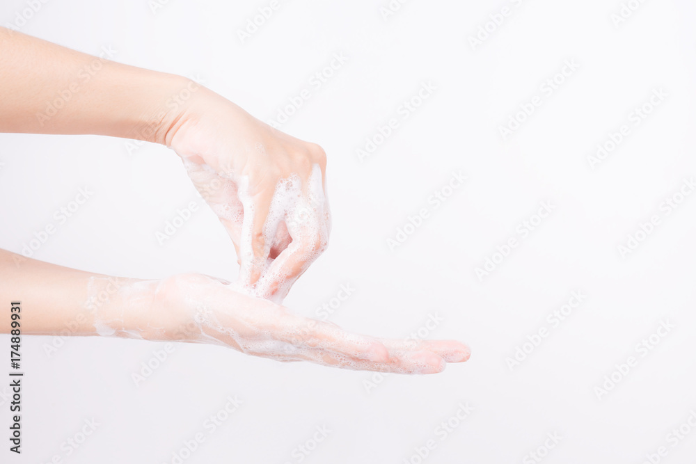 Asian girl hands are washing with soap bubbles on white background