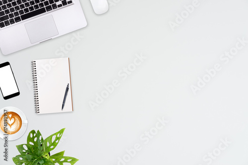 Modern workspace with laptop tablet, smartphone and coffee cup copy space on color background. Top view. Flat lay style.