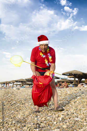 Mad Santa with bag on the beach