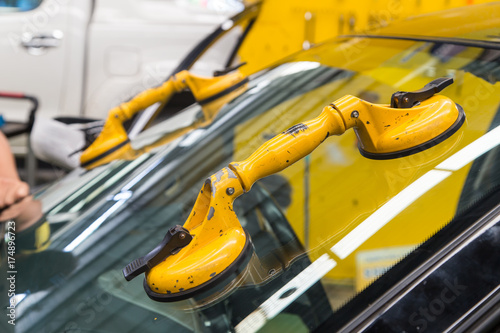 yellow suction cup lifter on windshield