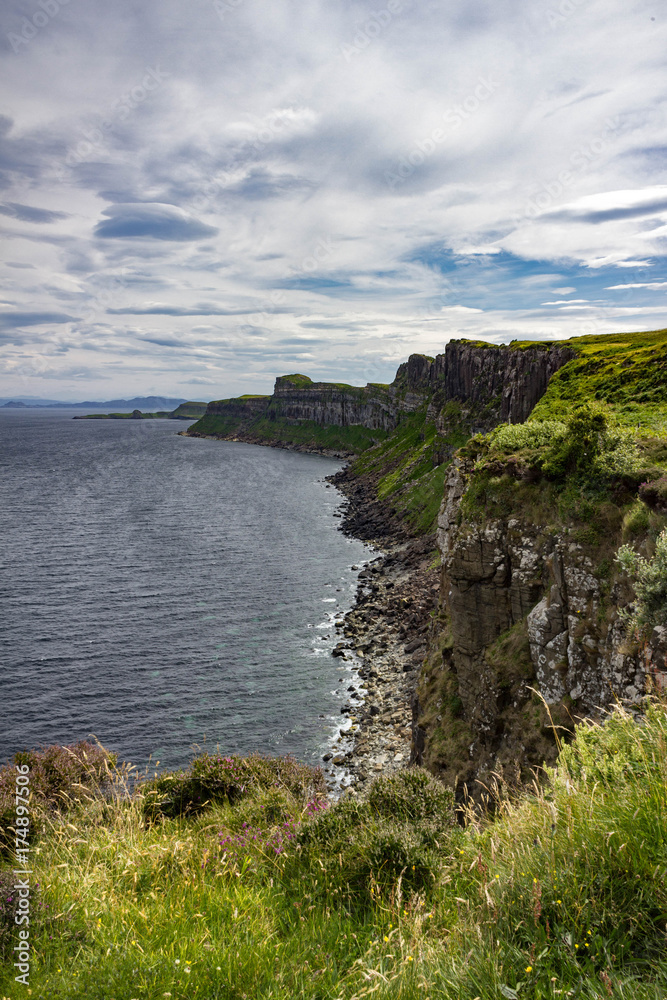 Gorgeous Vertical view of the sea-cliffs of the Trotternish Peninsula across from Kilt Rock on the Isle of Skye in Scotland.