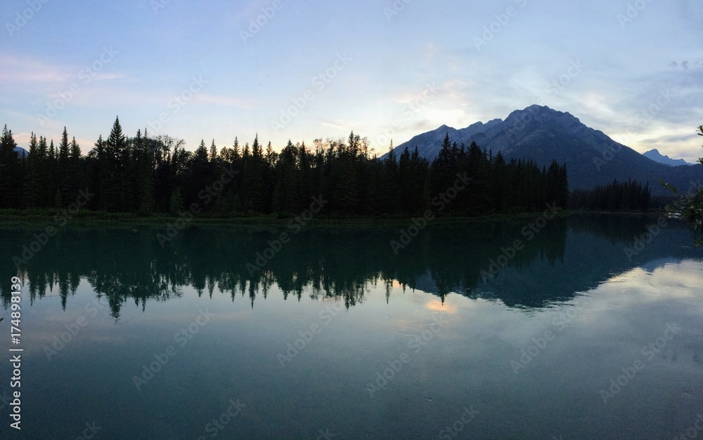 Banff, Bow River, evening reflection with mountain in background Banff, Bow River, evening reflection with mountain in background