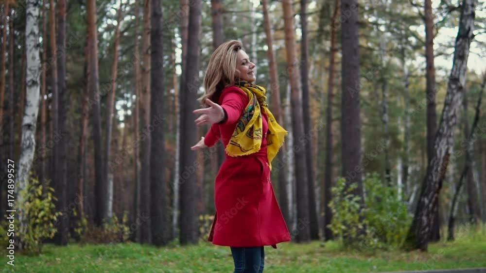 beautiful young woman enjoying warm autumn day and a fun spinning in the autumn forest. slow motion beautiful young woman enjoying warm autumn day and a fun spinning in the autumn forest. slow motion