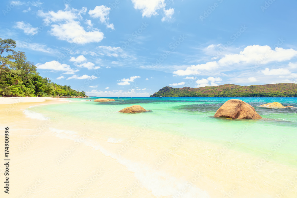 View at turquoise blue lagoon with large boulders in the water