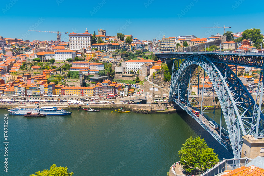 Porto, Portugal, panorama of Dom Luis bridge, the river Douro and tiles roofs 
